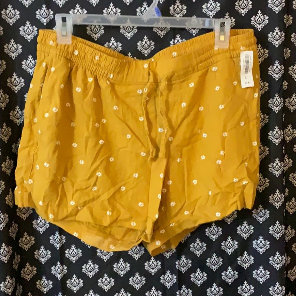 Mustard yellow flowy shorts.